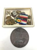 A WWI death plaque named to William Tweddell, together with a quantity of military badges,