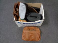 A box containing a quantity of assorted lady's handbags, laptop bag, vanity cases,