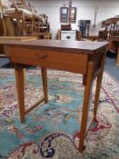 A mid 20th century teak sewing machine table