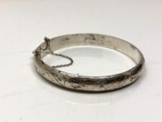 A sterling silver bangle with safety chain