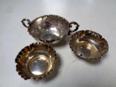 A silver twin-handled wine tasting cup together with a pair of silver salts.