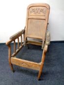 An Edwardian oak adjustable armchair.