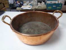 A 19th century copper and brass twin handled cooking pot