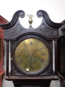 A profusely carved oak cased grandfather clock by Woolley of Codnor,