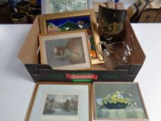 A box of assorted framed pictures, cut glass water jug, framed pottery tile,