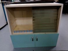 A mid 20th century sliding glass door kitchen wall cabinet fitted cupboard beneath.