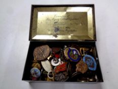 A 1953 Coronation tin containing assorted 20th century enamelled badges,