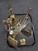 A tray of antique metal wares to include embossed bell, fire companion brush and pieces,