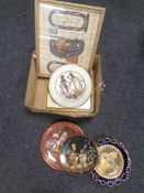 A box of two Egyptian prints, four Egyptian wall plates,