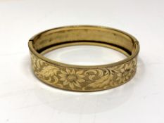 A vintage rolled gold cuff bracelet with floral decoration