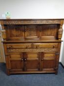 A 20th century carved oak buffet backed sideboard