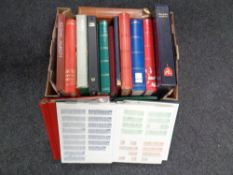 A box of a quantity of stamp albums and folders containing 20th century world stamps.