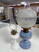 An antique Flash of Slough blue glass and brass oil lamp with chimney and shade together with a