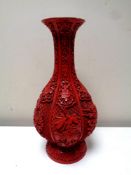 A Chinese carved red Cinnabar lacquer fluted vase, the intricate sides decorated with flowers,