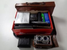 A tray containing cameras and camera equipment to include Halina camera in leather case,