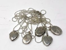 A collection of silver lockets with chains