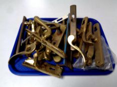 A tray of brass door handles and a brass letter box