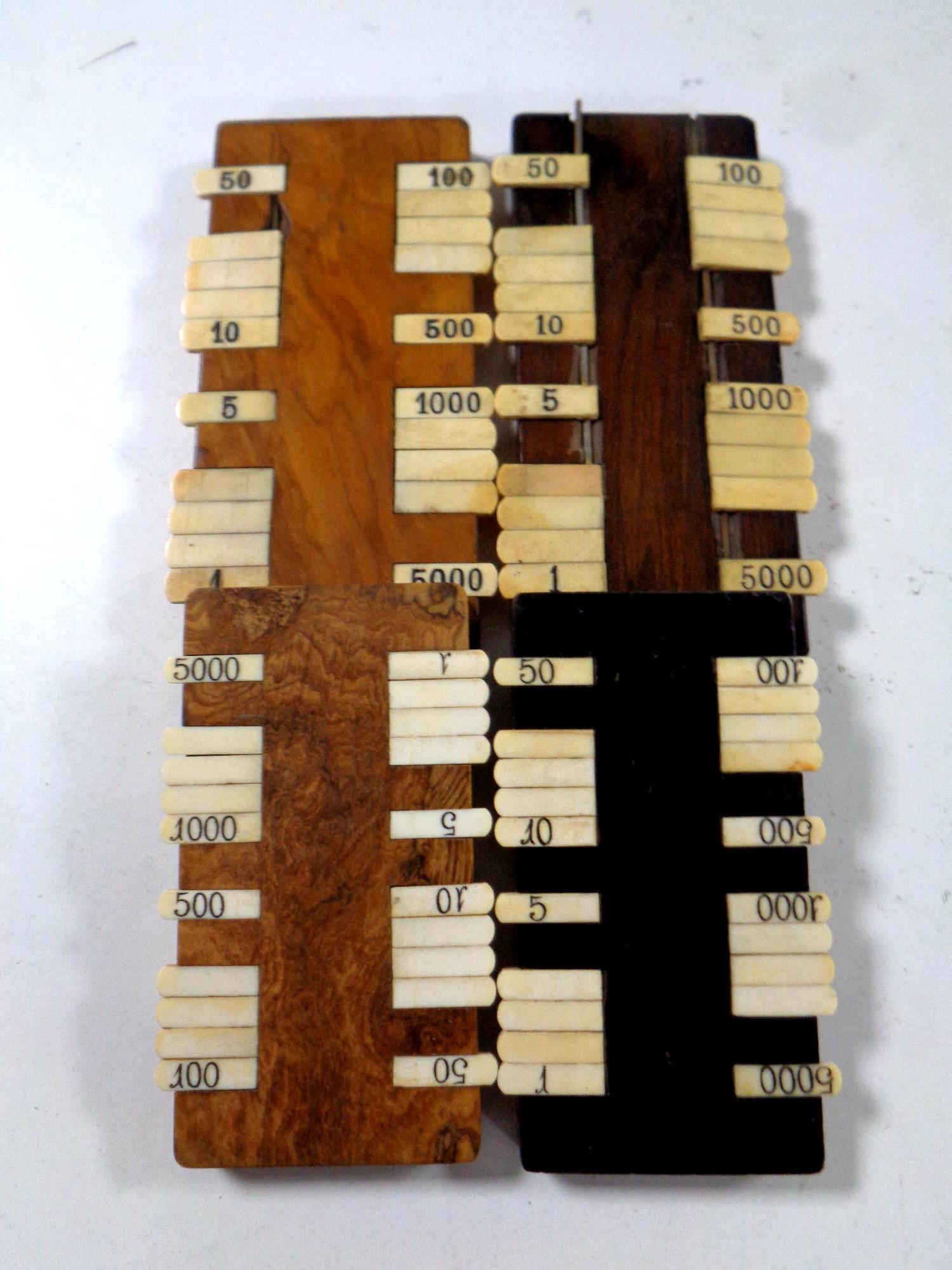 Four 19th century game markers.