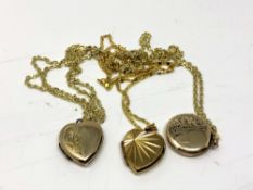 Three rolled gold lockets on chains