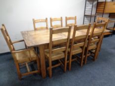 A good quality farmhouse extending dining table with leaves and eight rush seated ladder back