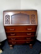 A 20th century oak writing bureau fitted four drawers