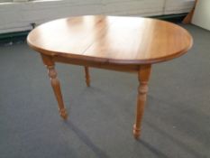 An oval pine extending kitchen table