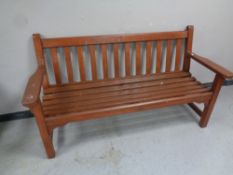 A stained wooden garden bench,