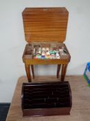 An Italian style musical occasional table containing sewing equipment and a correspondence rack