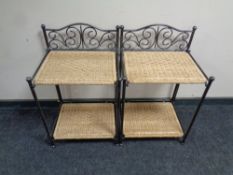 A pair of wrought metal and wicker two tier bedside tables
