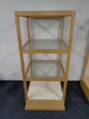 A square oak shop display stand with three glass shelves