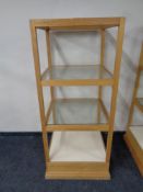 A square oak shop display stand with three glass shelves