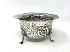 A silver sugar bowl with embossed panels depicting animals, Birmingham 1976,