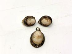 A cameo pendant with matching clip earrings
