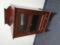 An Edwardian mahogany glazed door music cabinet fitted a drawer