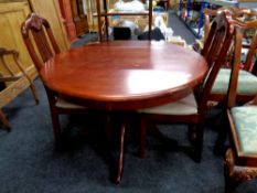 A circular rubber wood kitchen table and two chairs