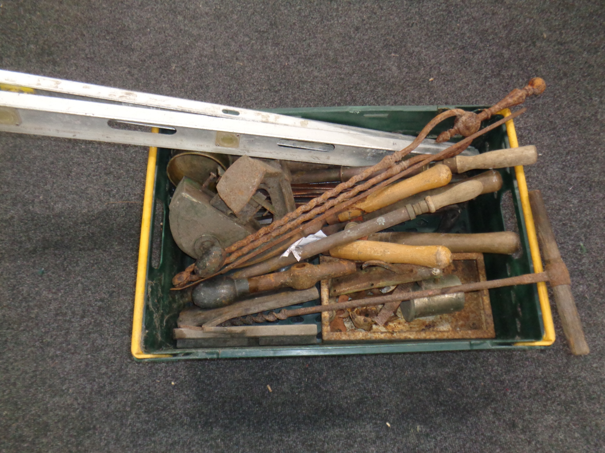 A crate of antiquarian hand tools, fire companion pieces, cobbler's last, door lock,