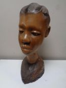 A carved hardwood bust - female figure