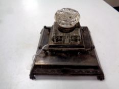 An antique silver plated desk stand with cut glass ink well