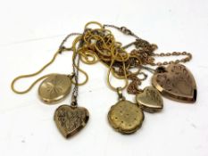 A collection of gold plated lockets with chains