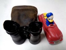 A cast iron novelty car "Donald Duck and Pluto" and a pair of antique field glasses in leather case