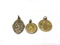 Two religious pendants together with one other