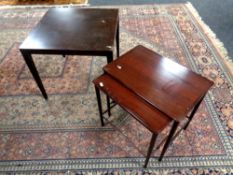A mid 20th century Danish nest of two tables in a mahogany finish and a lamp table