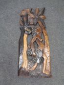 A carved hardwood Eastern panel - native female with child