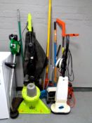 A petrol weed eater together with an electric garden strimmer and garden vacuum,