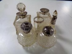 Six assorted antique cut glass silver topped and rimmed scent bottles, vase.
