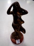 A bronze figure of a maiden on a circular marble base, height 12.