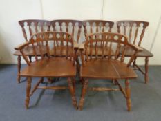 A set of six beech American style dining chairs comprising of two carvers and four singles