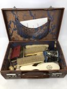 A vintage leather case containing Acme whistle, Girl Guides ephemera, turned ivory darning tools,