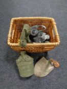 A basket of WWII items - water canteen, gas mask, shovel,