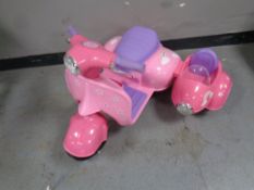 A child's electric motorbike with doll sidecar